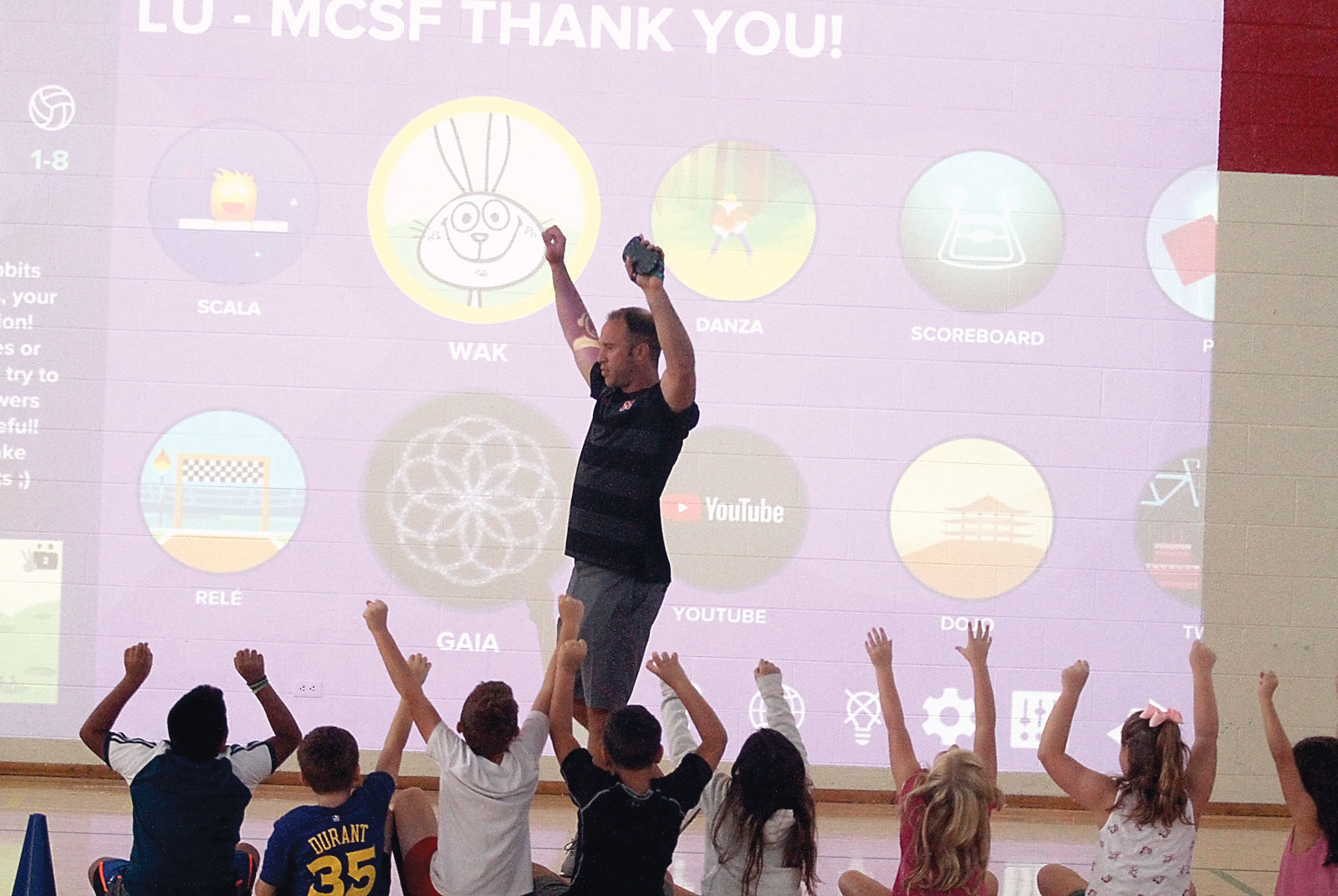 Physical education teacher Alex Rouse leads John Sevier Elementary students in exercises